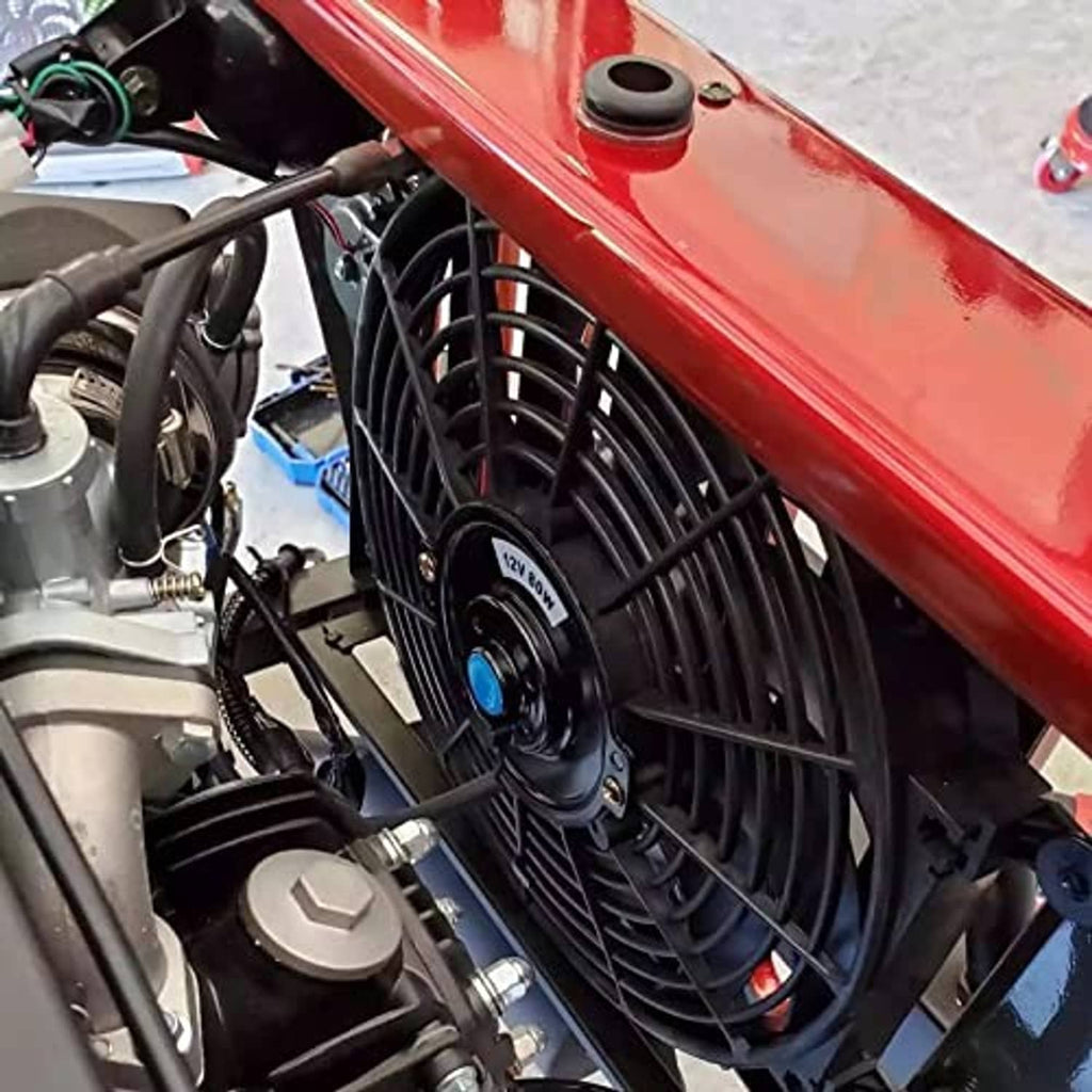 Electric radiator cooling fan installed in vehicle engine bay near radiator and hoses