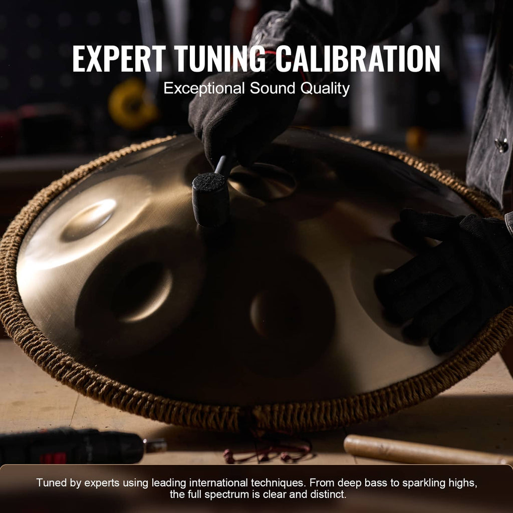 Golden handpan drum close-up with mallet striking the tone surface and note dimples