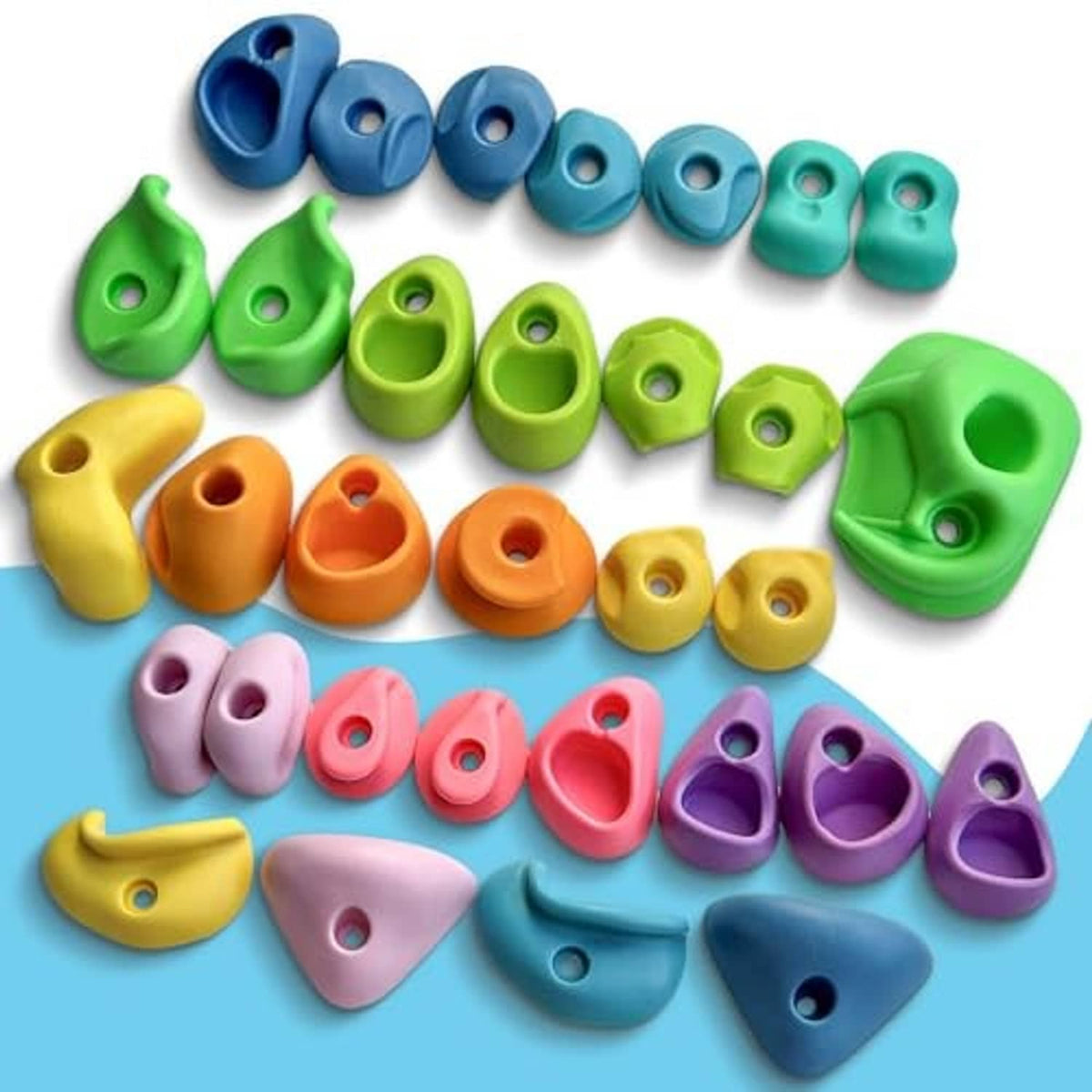 Assorted plastic climbing holds in blue, green, yellow, orange, pink, purple