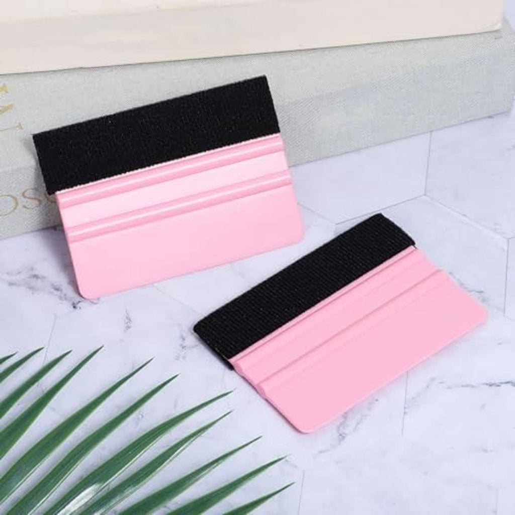 Pair of pink vinyl squeegee tools with black felt scraper pads