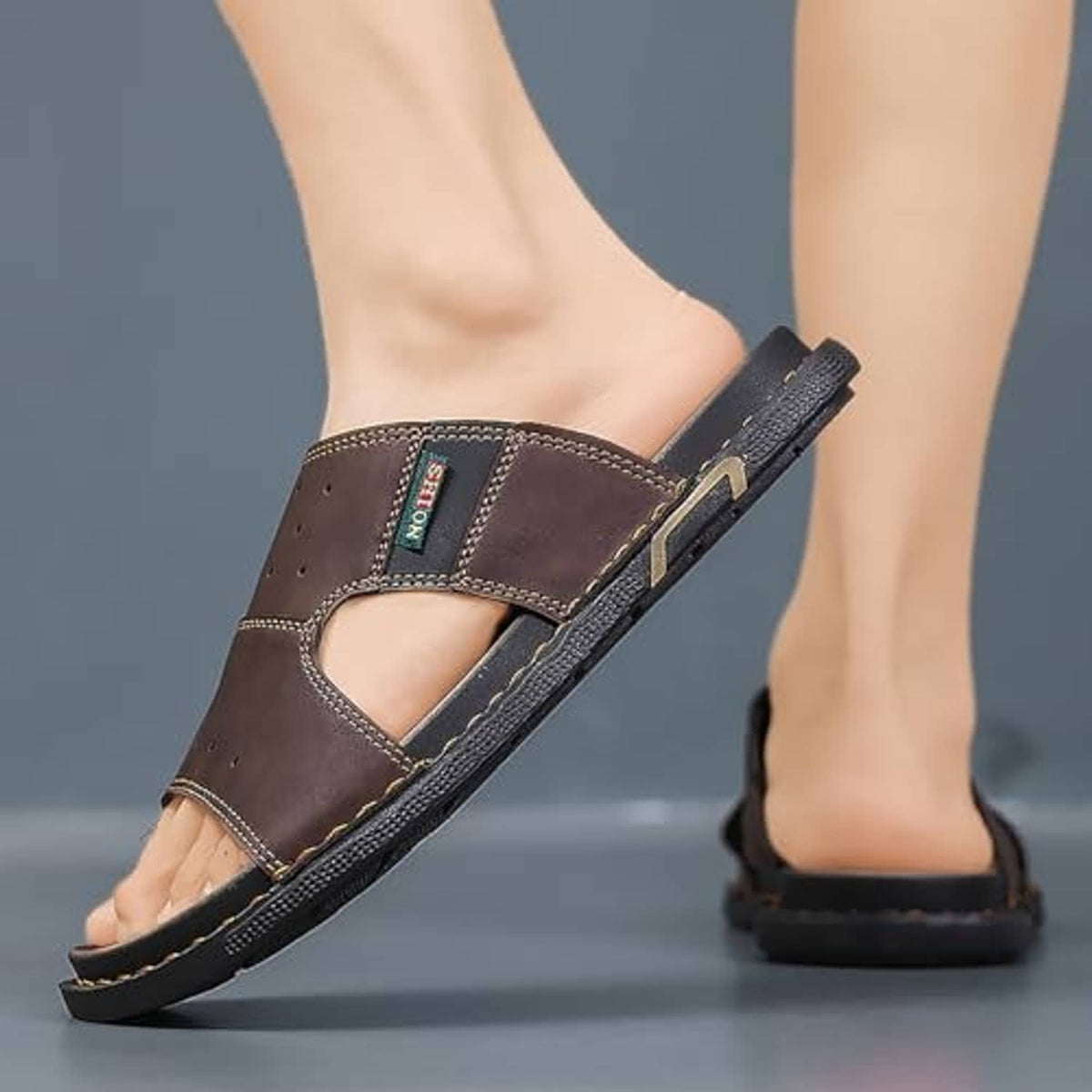 Men's brown leather open-toe slip-on sandal with stitched cross strap and dark sole