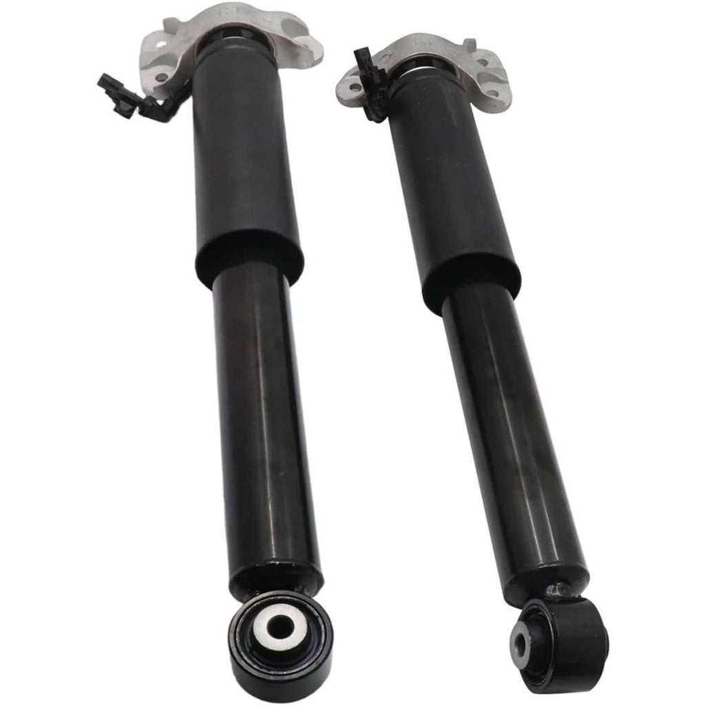 Two black rear shock absorber struts with top mounts and bottom rubber bushing rings