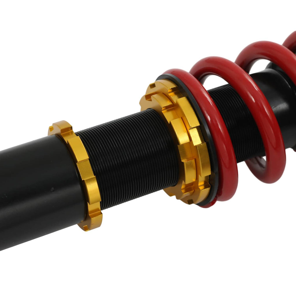 Coilover shock absorber showing black threaded body with gold adjustment ring and red spring