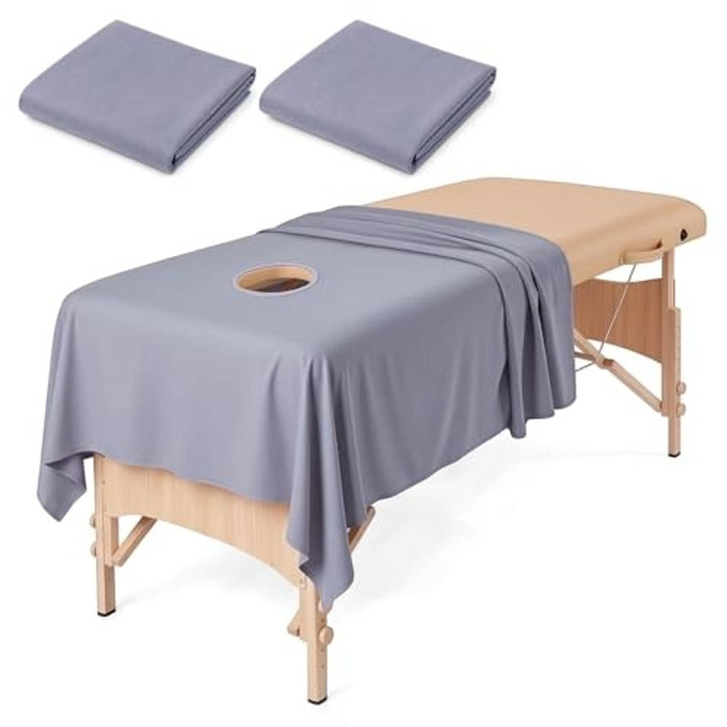 Gray massage table sheet with circular face hole, draped over a massage table
