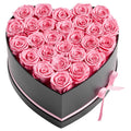 Heart-shaped box of pink preserved roses with satin ribbon bow, black and pink