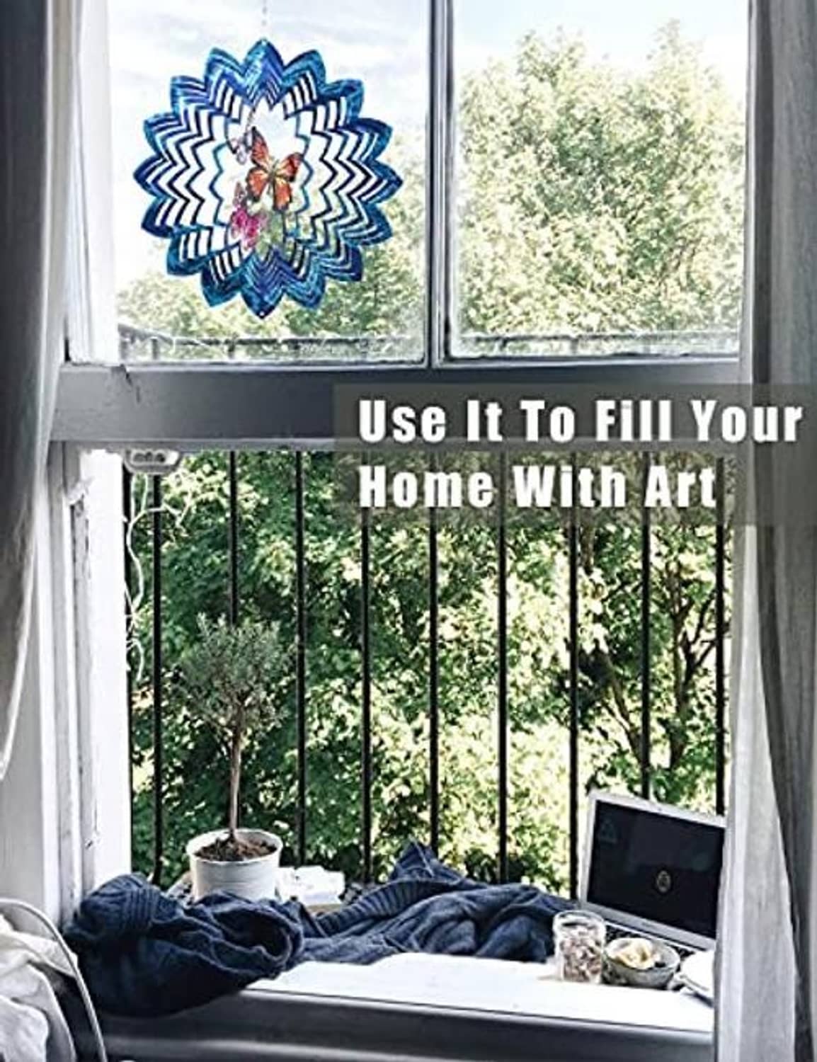 Blue butterfly wind spinner hanging near window with small matching flower charm