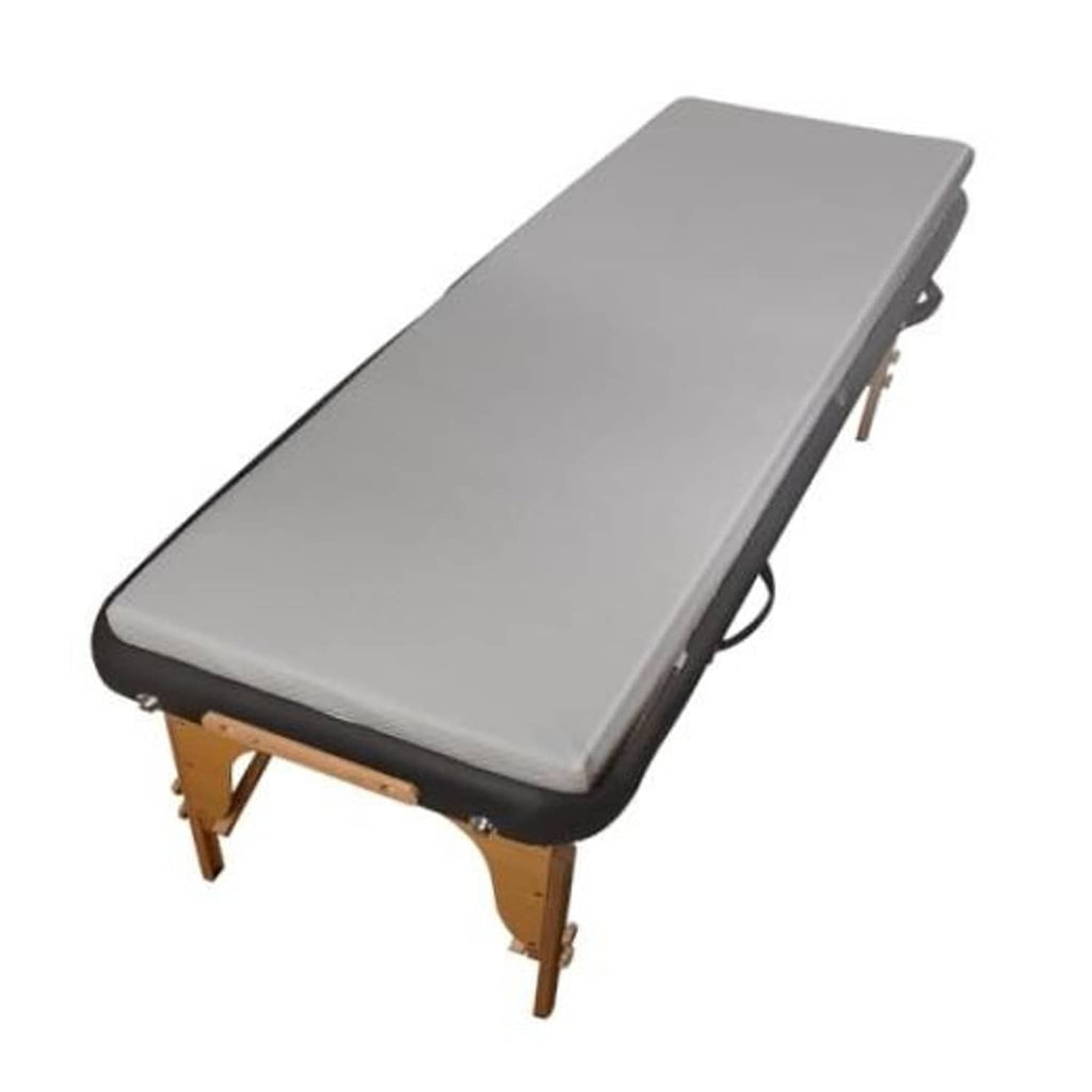 Grey memory foam massage table topper with dark trim and fitted elastic edge sleeves