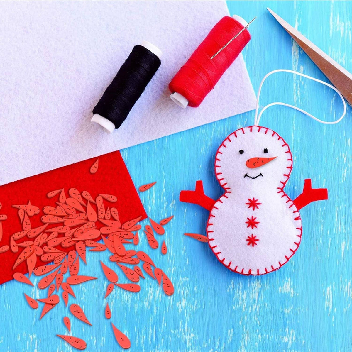 Red water-drop wooden buttons with face details, scattered for crafts