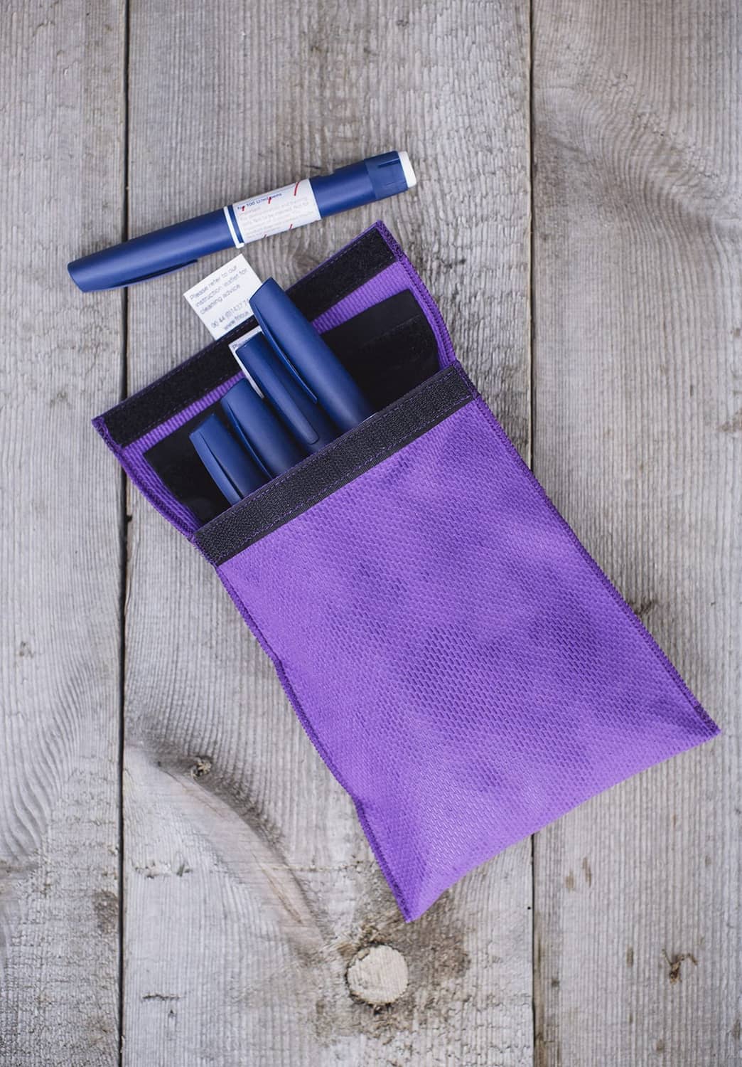 Purple cooling wallet pouch opened with storage slots for insulin pens and vials