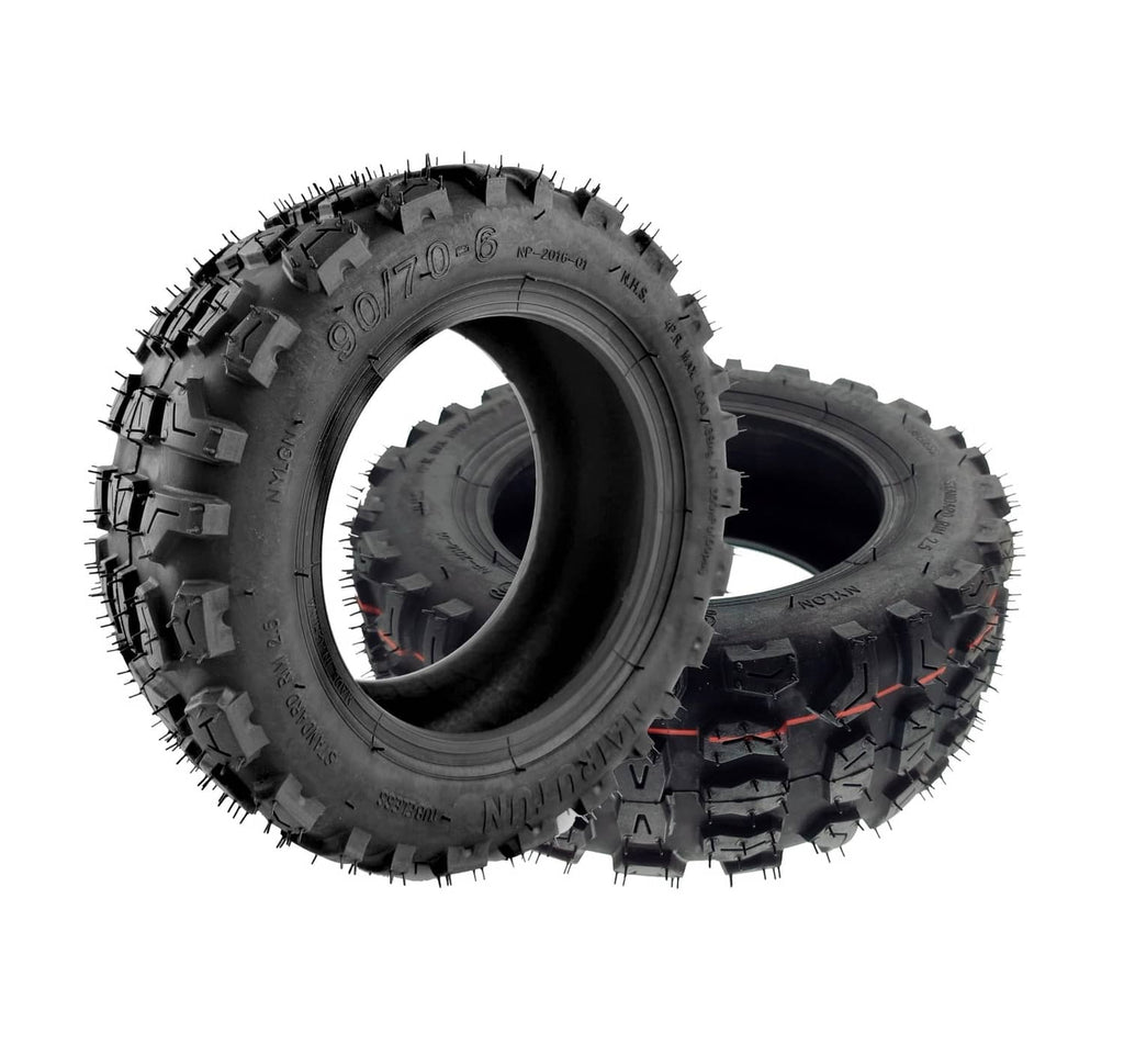 Off-road tubeless tire angled view showing deep tread and sidewall markings