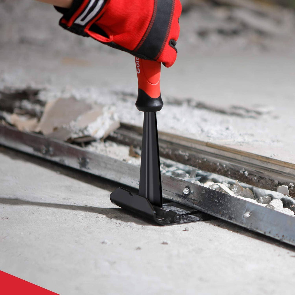 Trim puller tool with black base prying along floor edge beside baseboard