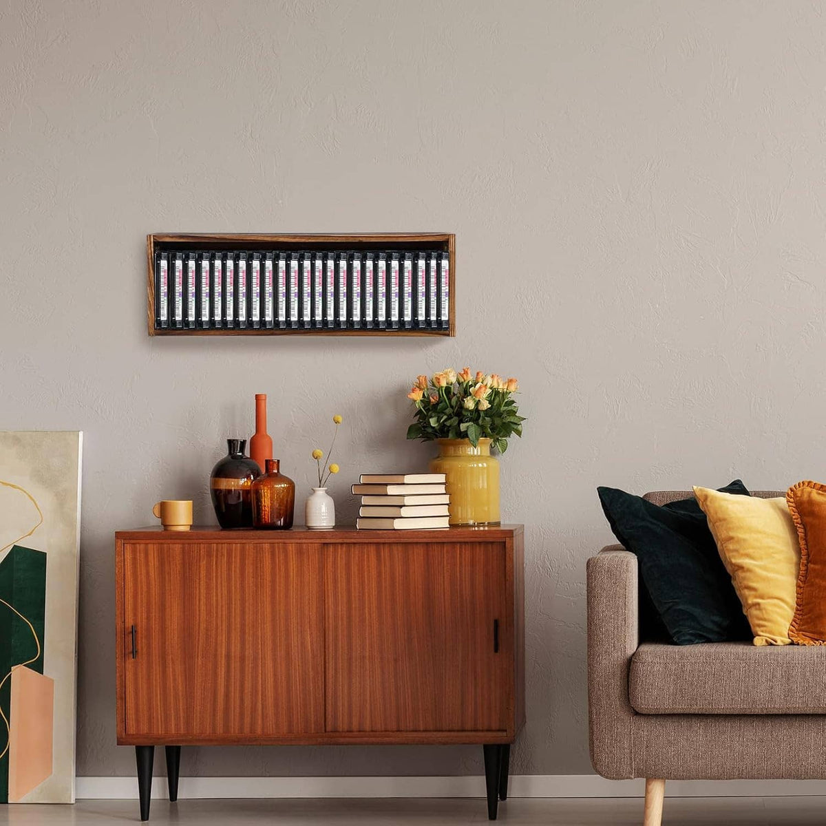 Wooden cassette tape storage cabinet mounted on wall with cassette tapes visible
