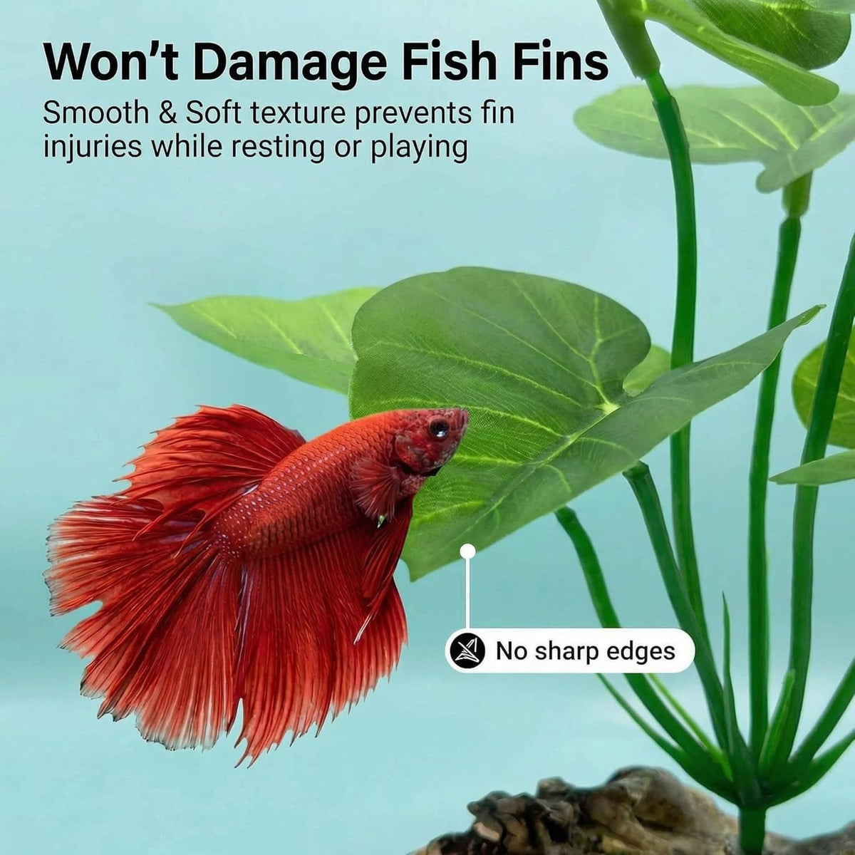 Artificial aquarium plant with green leaves beside a red betta fish