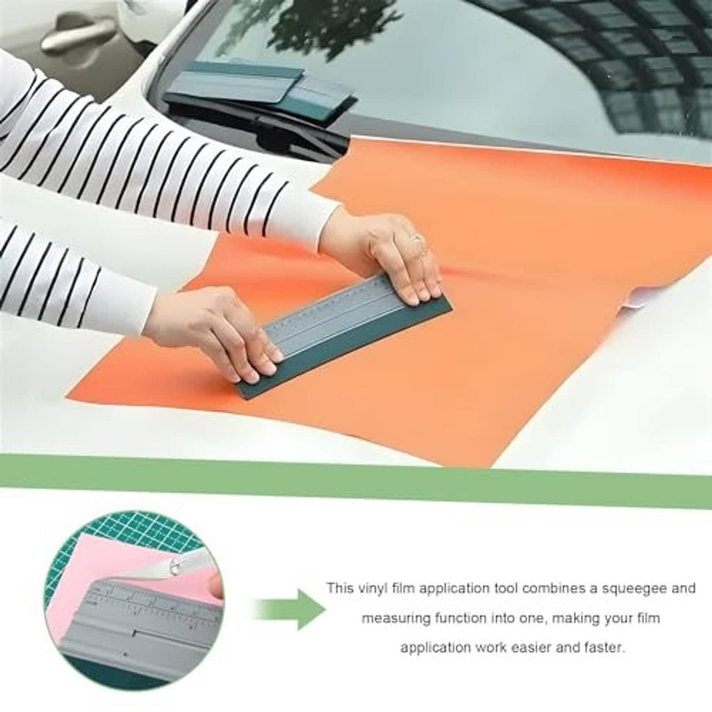 Felt squeegee applicator smoothing an orange vinyl film on a car surface