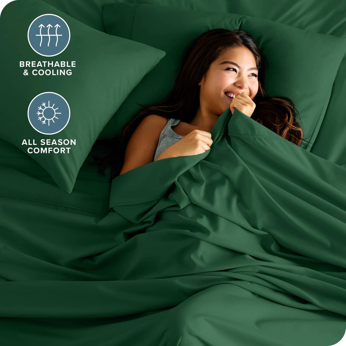 Forest green microfiber sheets covering a sleeper, smooth fitted bedding