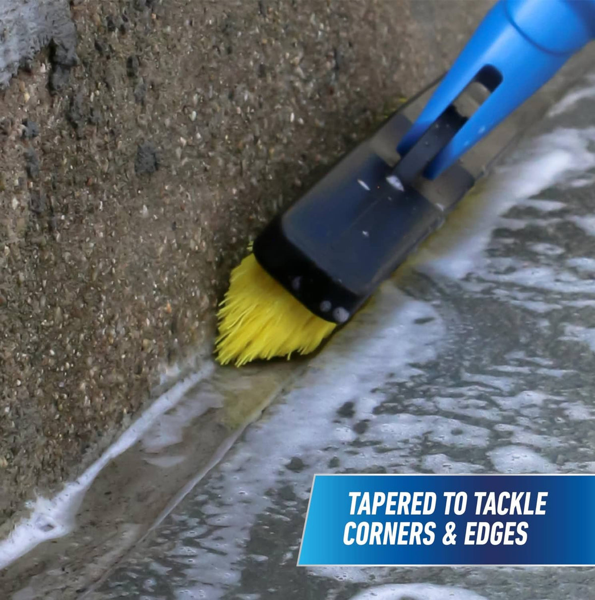Corner grout brush cleaning concrete with tapered head and yellow bristles