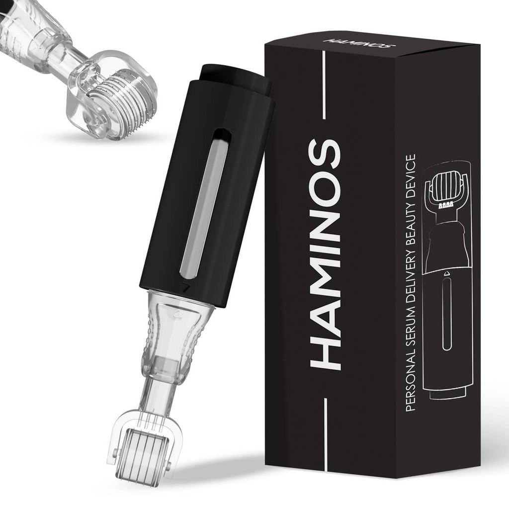 Derma roller with clear reservoir cartridge and black handheld applicator