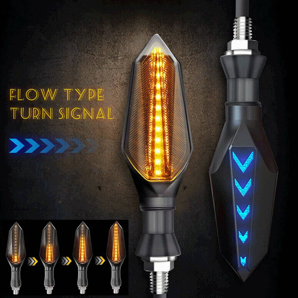 Flow-style amber LED turn signal lamp with blue arrow accent on black housing