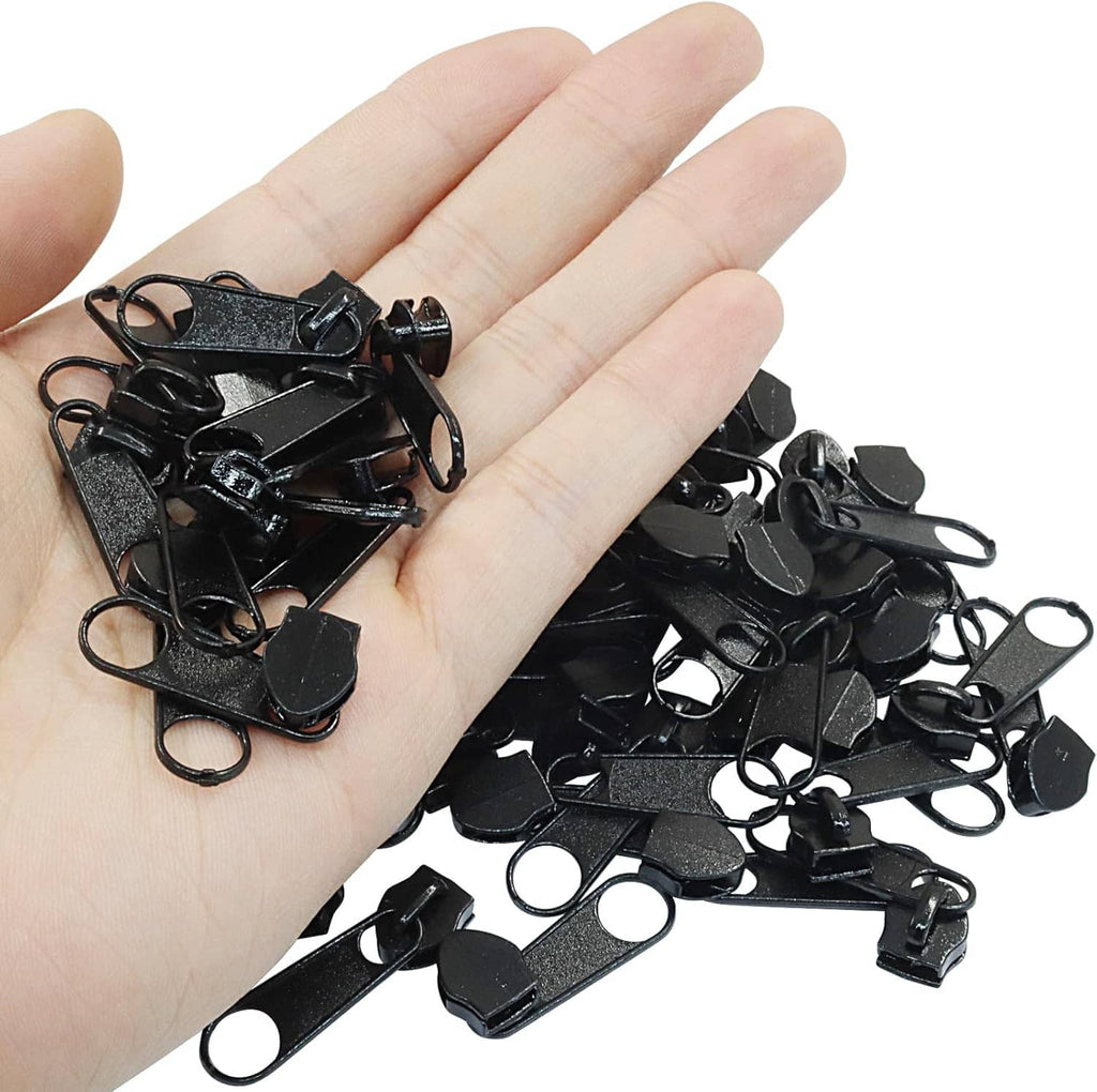 Black zipper slider replacements held in hand, showing clip and loop details