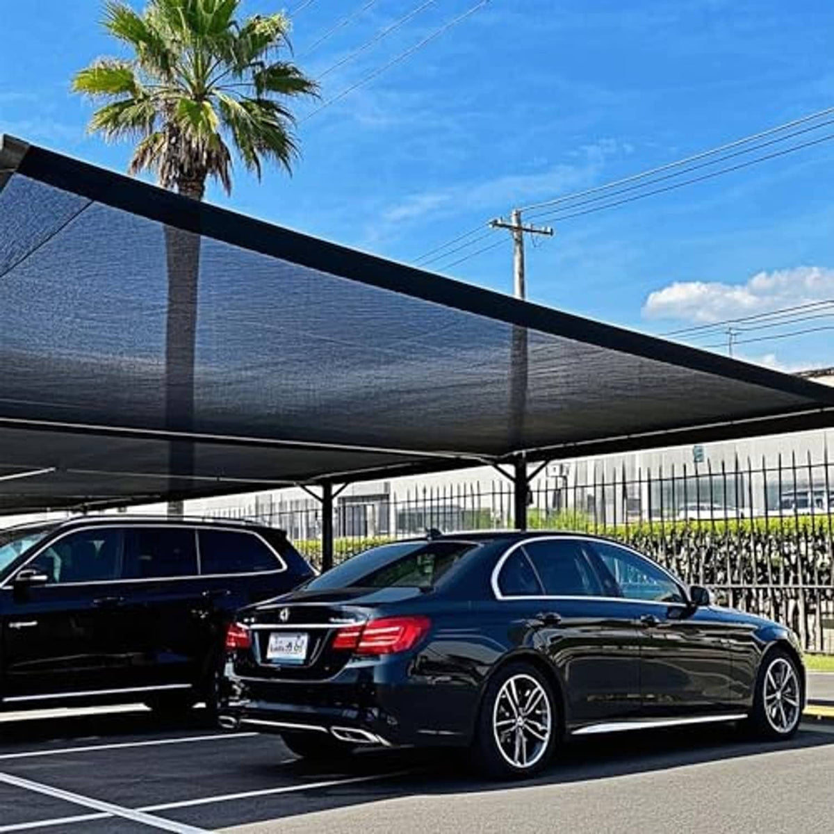 Black shade cloth mesh tarp stretched over an outdoor area