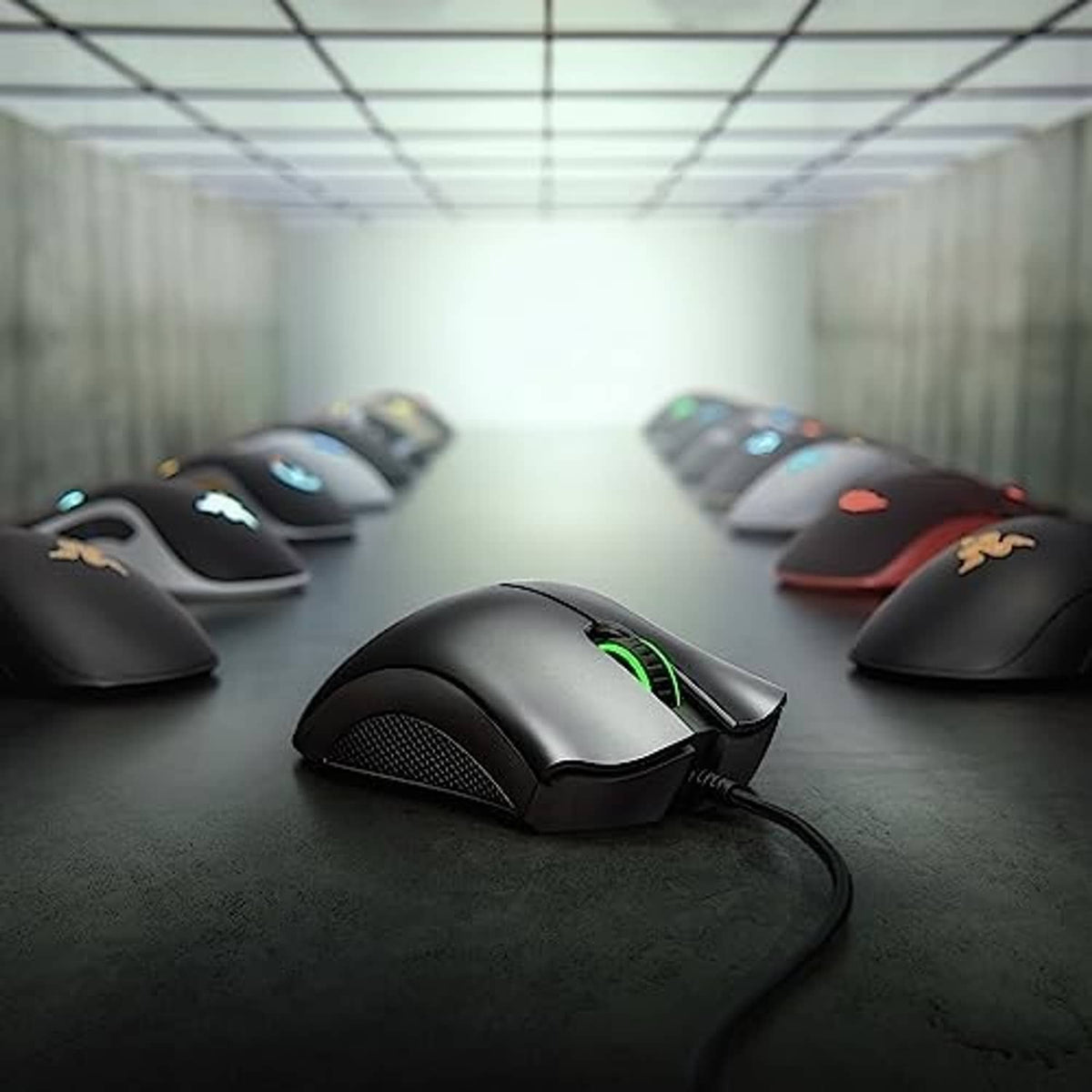 Black wired gaming mouse with glowing RGB accents and textured side grips on mat.