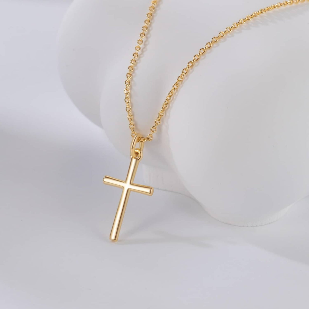 Gold-tone cross pendant necklace on cable chain, angled pendant on bust