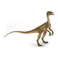 Hand-painted Compsognathus dinosaur figurine with long tail and four legs.