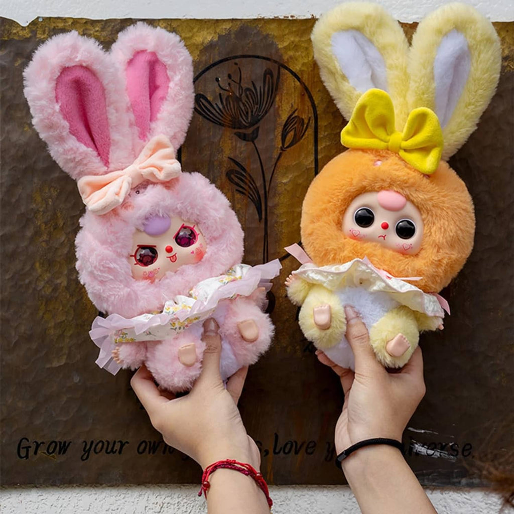 Pink and yellow-orange rabbit plush figures held in hands, each with ruffled outfit