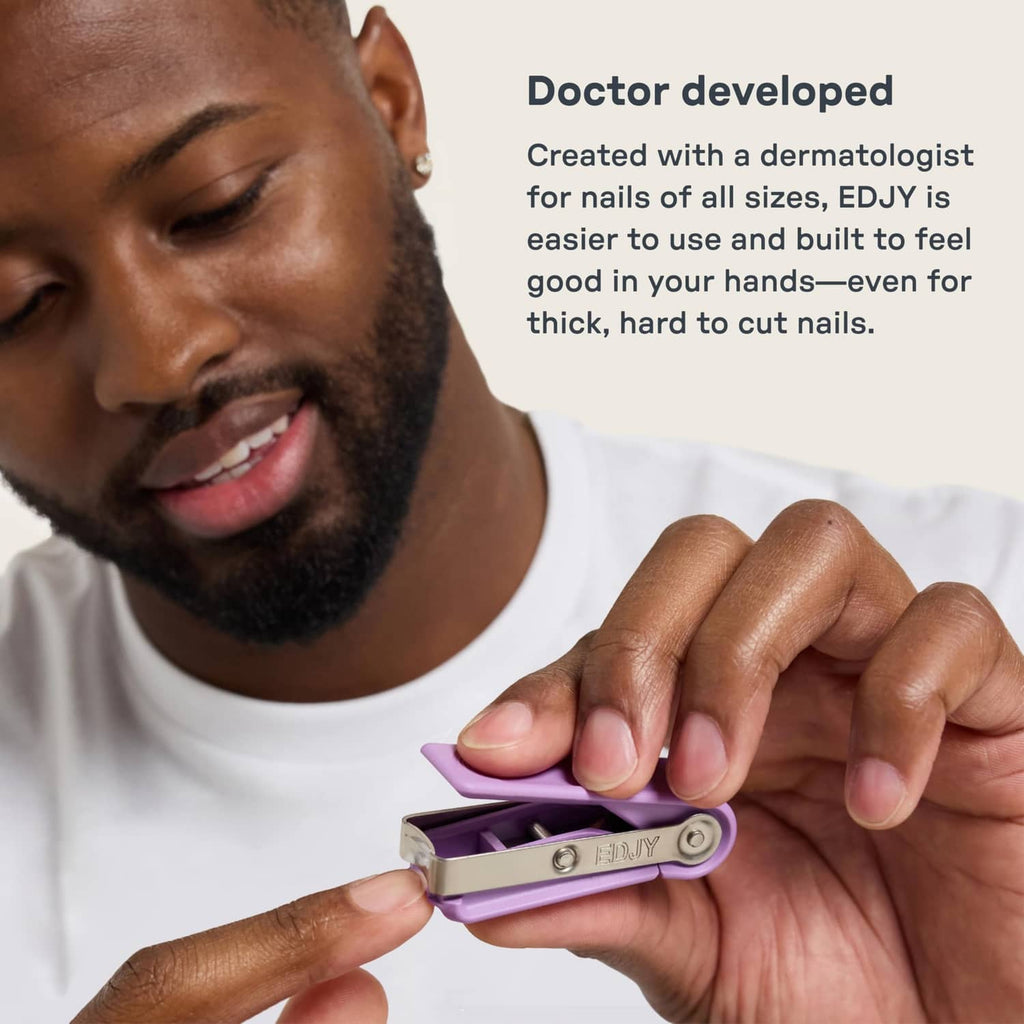 Purple fingernail cutter used on nails with a controlled cutting grip