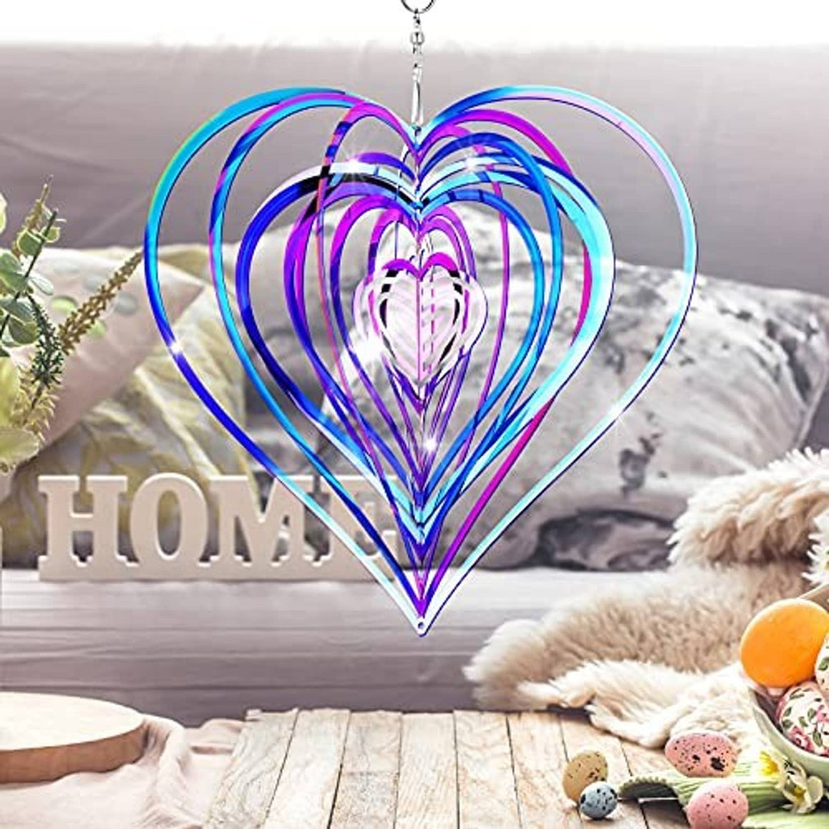 Colorful heart-shaped wind spinner with spiral metal coils, hung by a silver chain