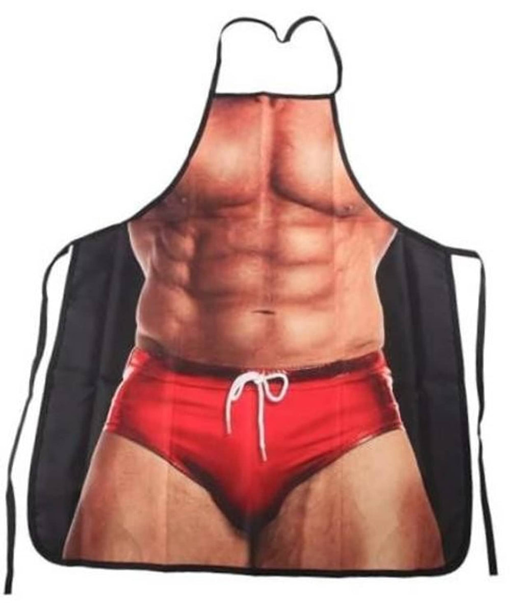 Novelty kitchen apron with black straps and red shorts graphic over bare torso