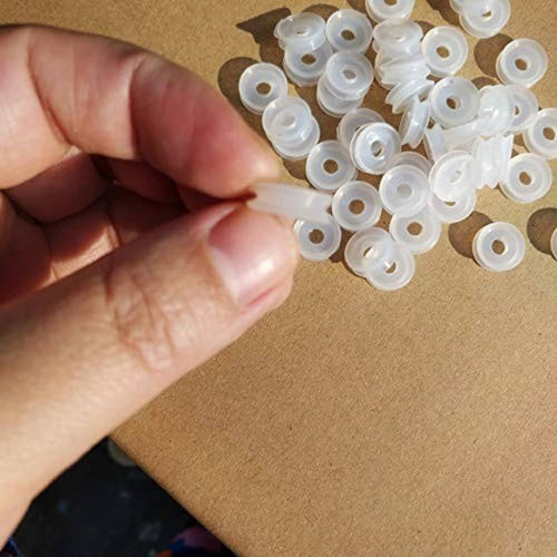 Set of small white plastic sealing rings held in a hand