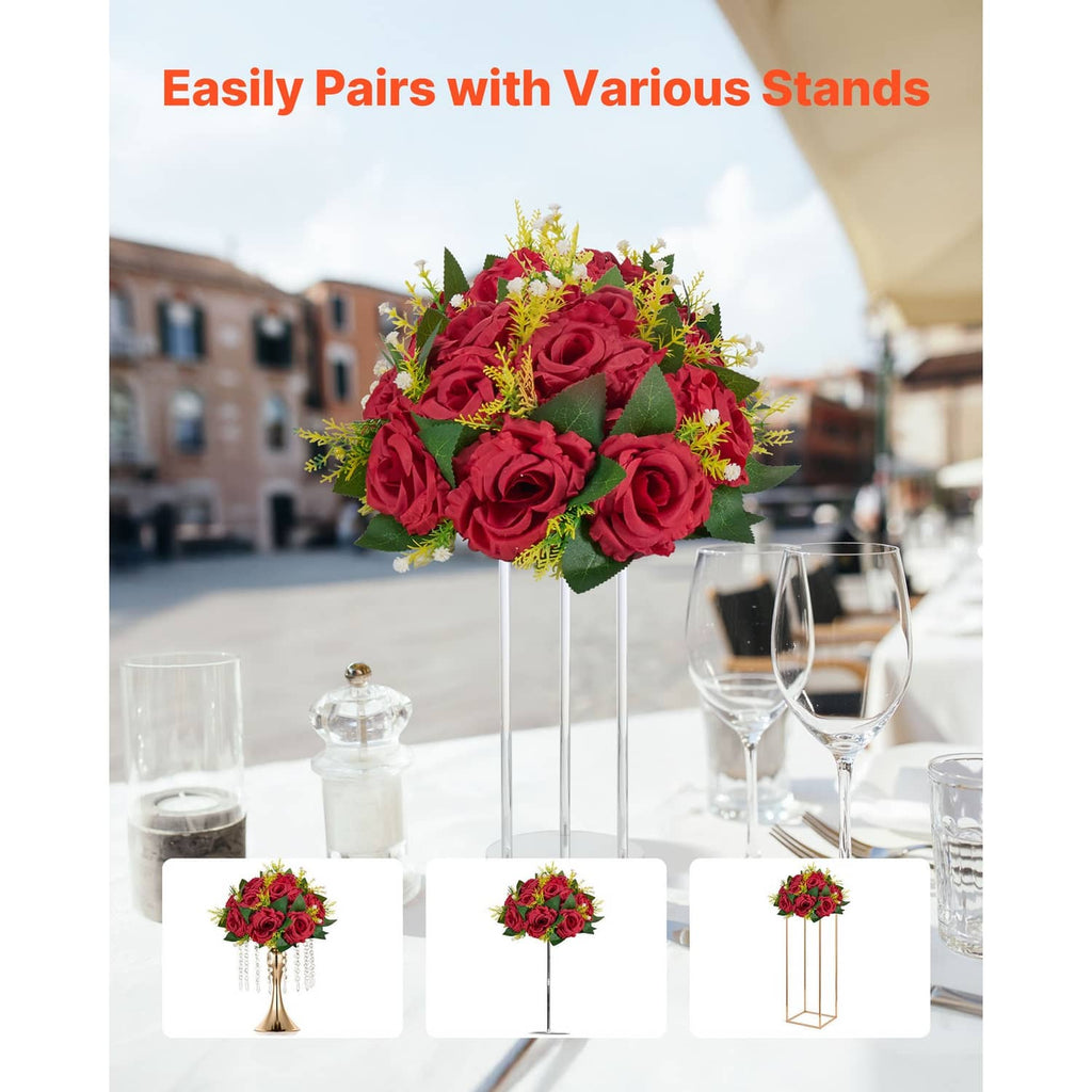 Red artificial flower ball centerpiece with roses and green leaves on a clear standing holder