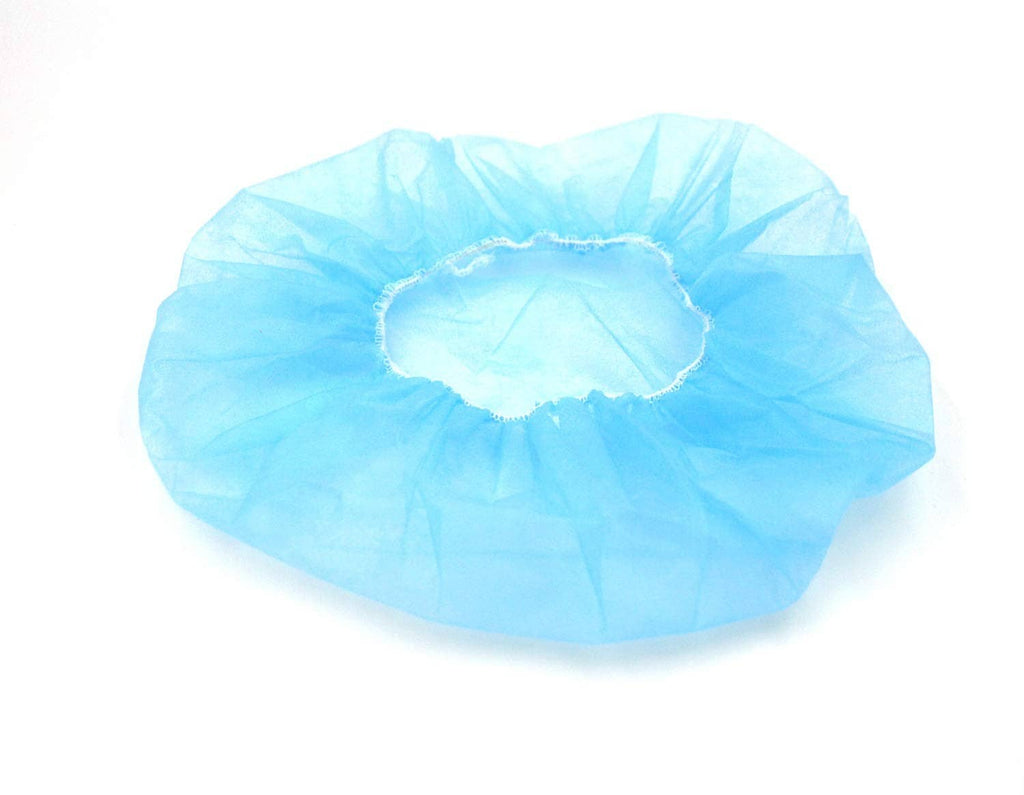 Blue disposable bouffant cap laying flat, gathered crown and elastic opening