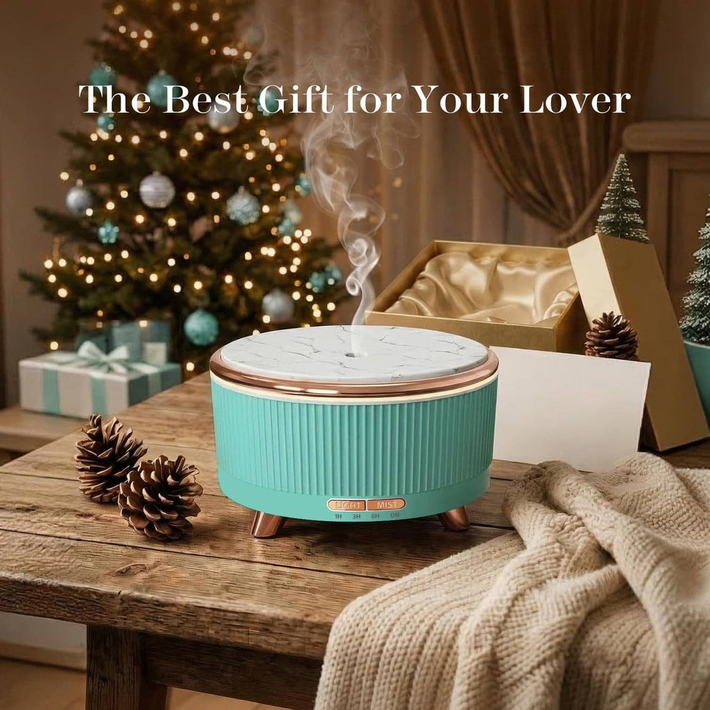 Emerald aqua essential oil diffuser with mist, marble lid, and copper feet on wooden table