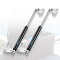 Pair of black gas spring lift struts with chrome rods and mounting brackets