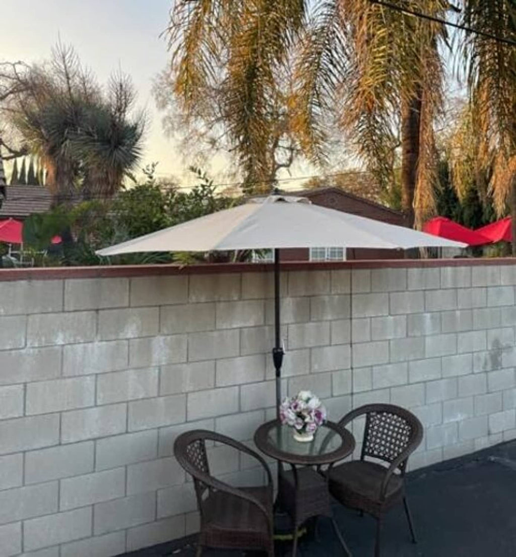 Light gray umbrella canopy with black support pole and pleated fabric