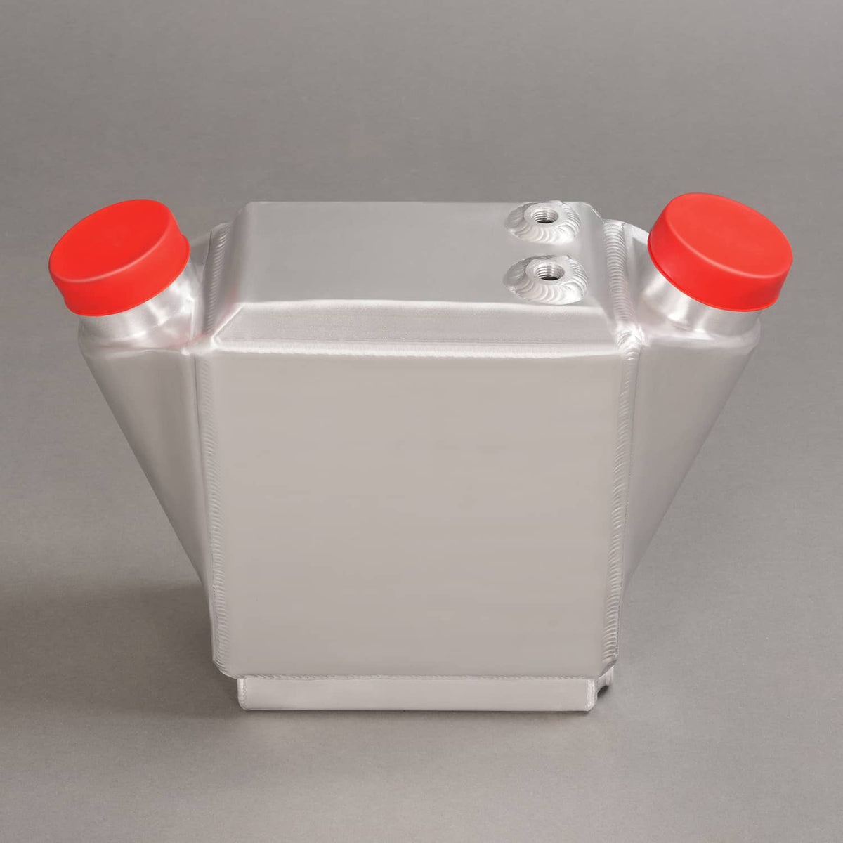 Aluminum intercooler with red end caps and top mounting plate, front view.