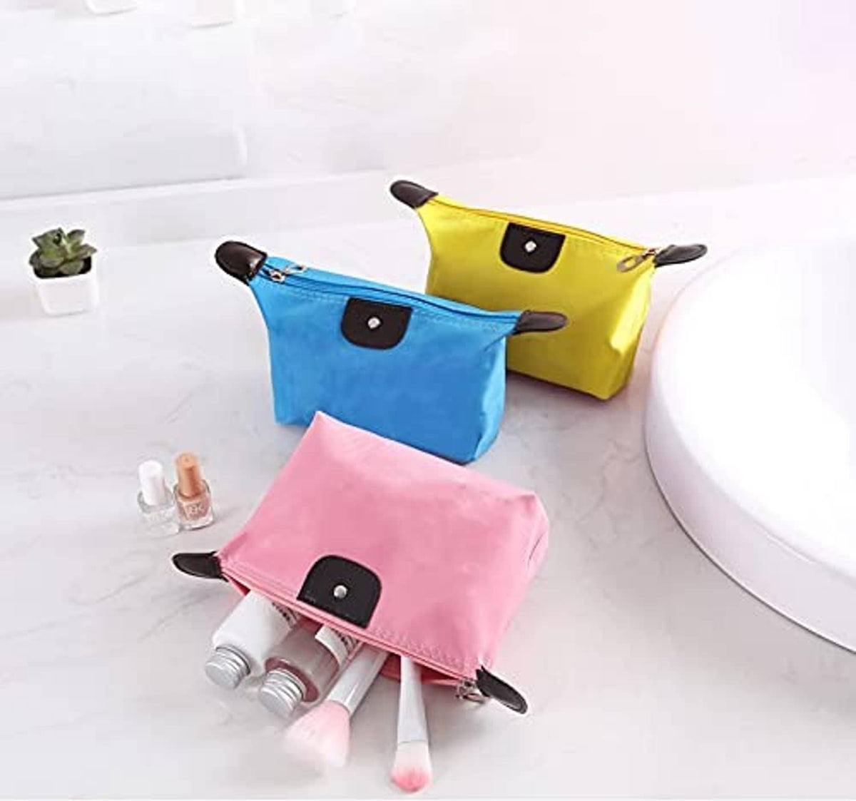 Colorful waterproof toiletry zip pouches (yellow, blue, pink) with front leather patch