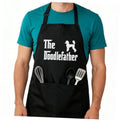 Black adjustable apron with “The Doodlefather” print and utensil icons on front pocket panel