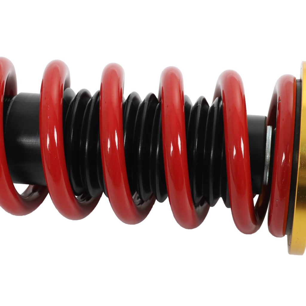 Close-up of red coil spring around a black shock body on a coilover