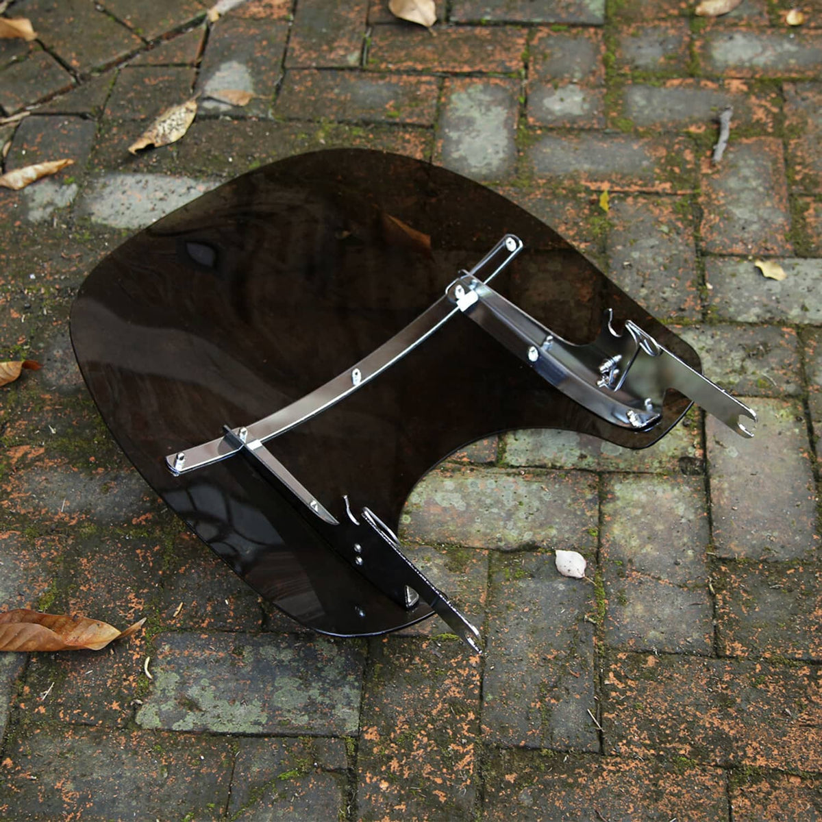 Dark tinted motorcycle windshield with silver mounting hardware and two support arms