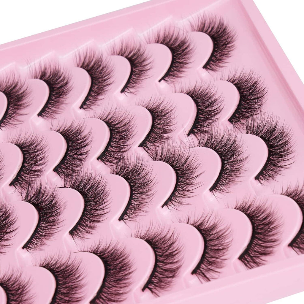 Close-up of dark cat-eye false lash bands in a pink tray, clustered
