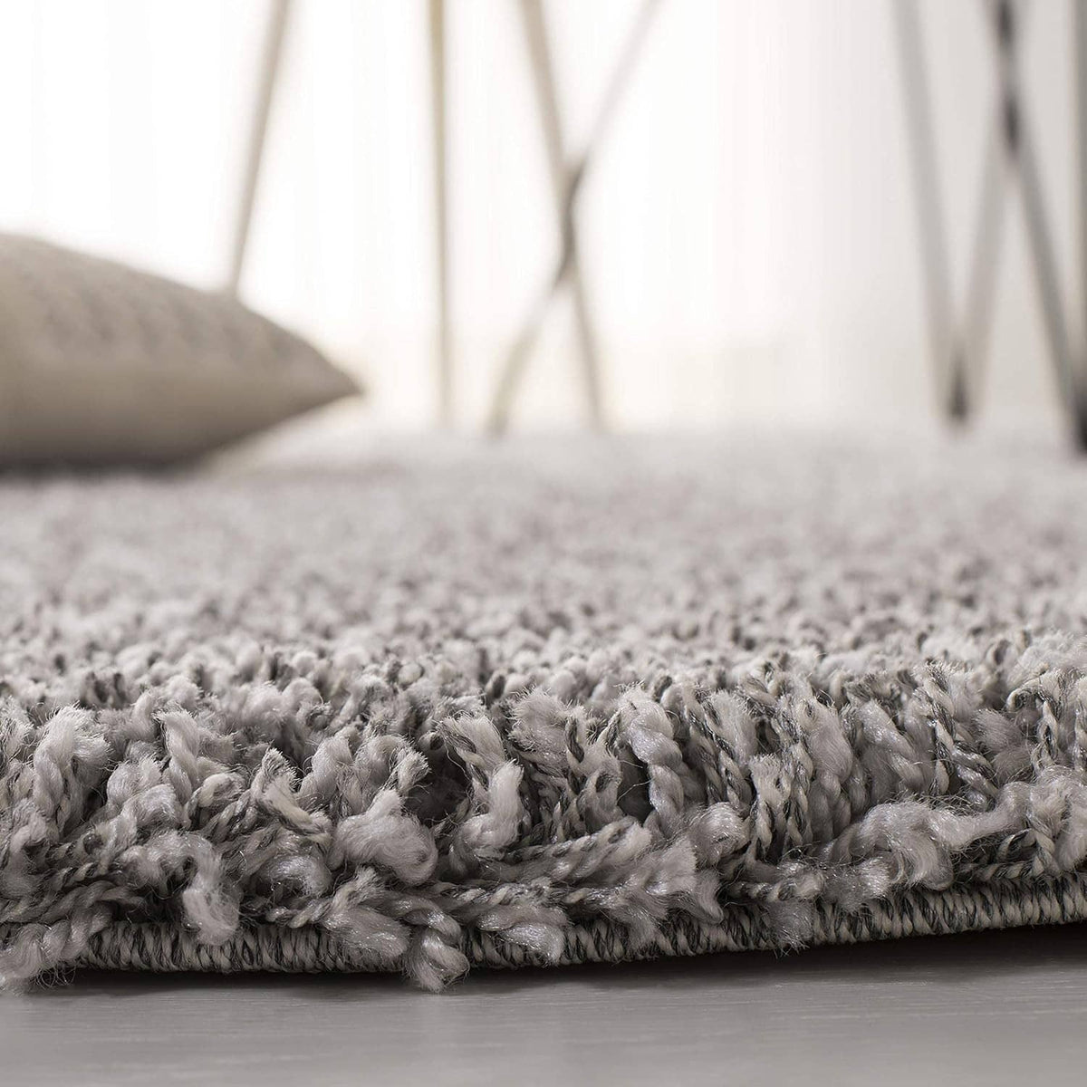 Silver shag rug with short looped pile and flat border edge