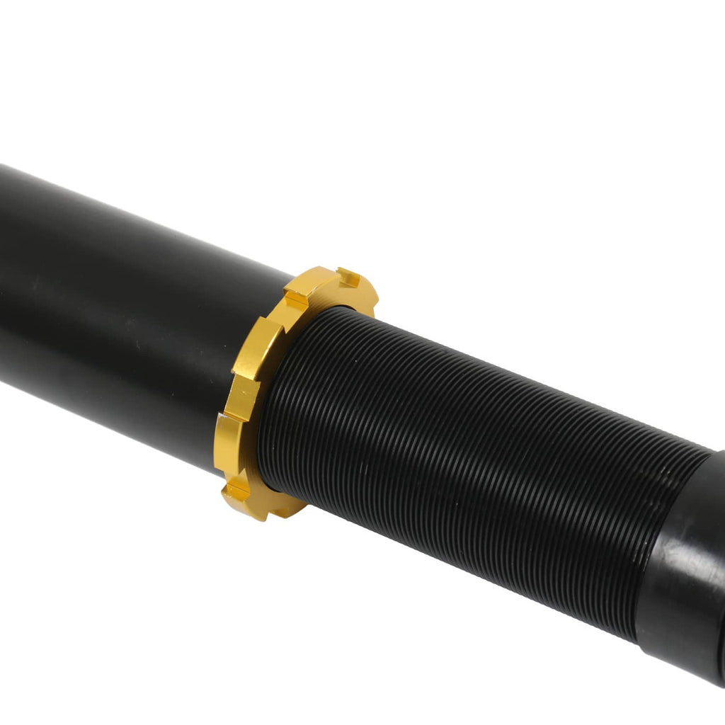 Close-up of black coilover strut spring with gold adjustment collar