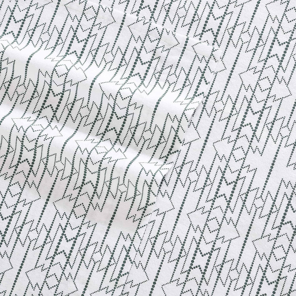 Close-up of white cotton flannel fabric with navy star and diamond geometric pattern