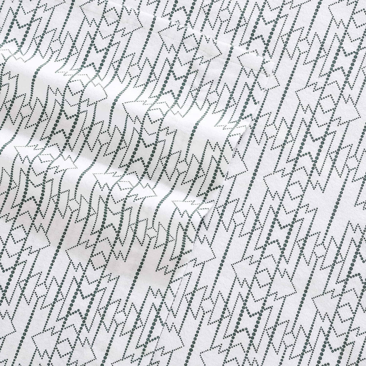 Close-up of white cotton flannel fabric with navy star and diamond geometric pattern