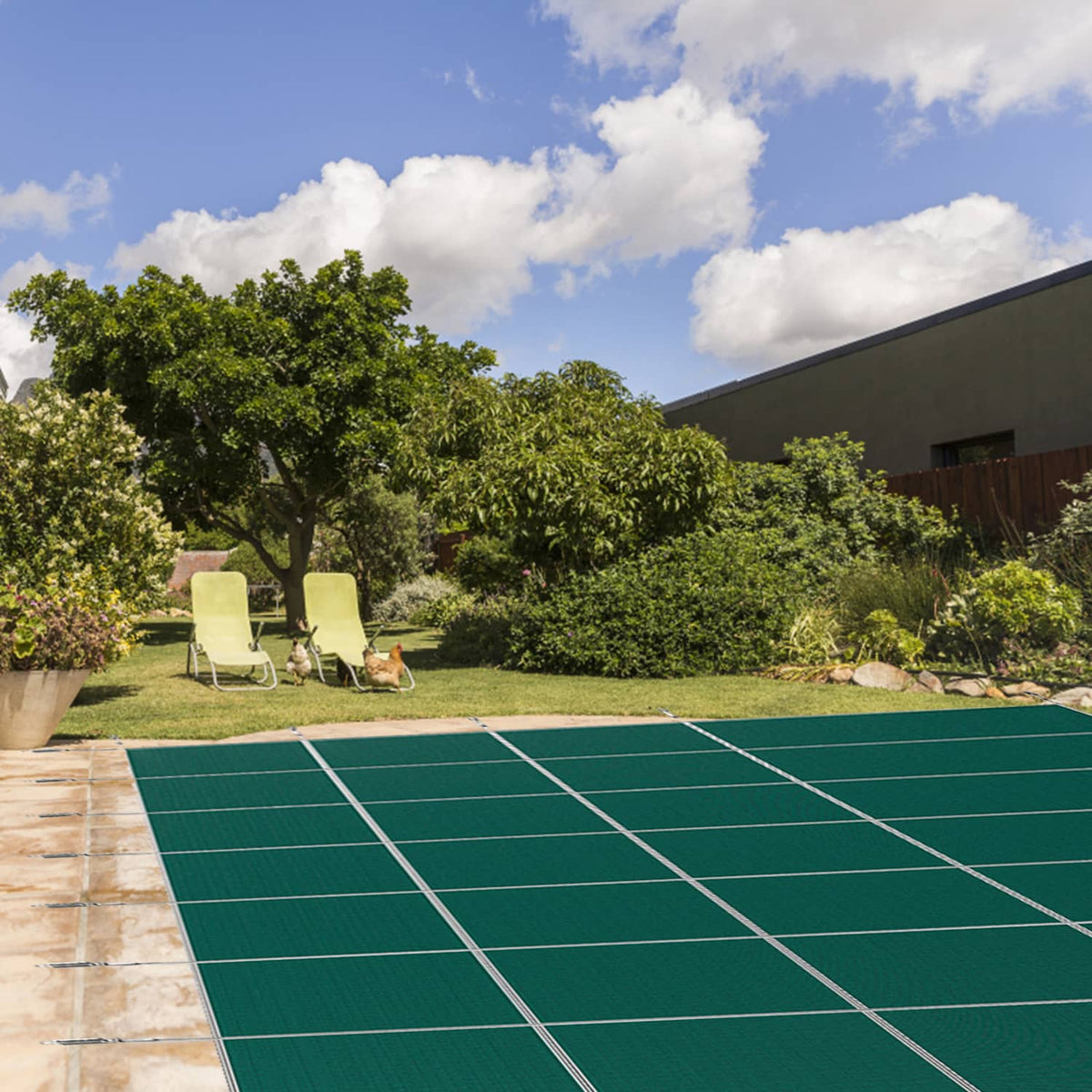Green inground pool safety cover laid flat with grid lines and edge anchor points