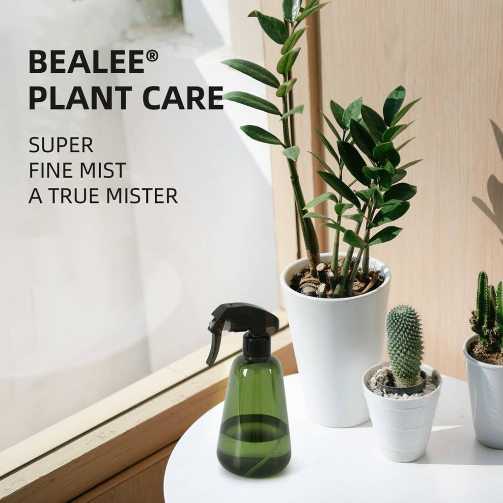 Green plant spray bottle on a windowsill beside potted plants