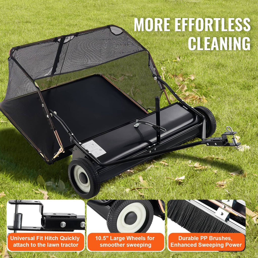 Tow-behind lawn sweeper on grass with black hopper cover and large front wheels